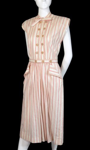 Claire McCardell striped dress design cut on lenghgrain with a cap sleeve all in-one with bodice, double breasted buttons effect, and contrast pocket and waistband strip detail.